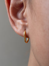 Gold hoop earring by LeeLoobird Jewelry Bali worn on an ear with a neutral background