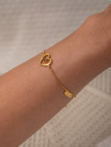 Cinta Gold bracelet by Leeloobird Bali with a heart-shaped charm on a textured white background