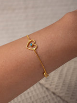 Cinta Gold bracelet by Leeloobird Bali with a heart-shaped charm on a textured white background