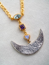 Energy Necklace by LeeLoobird Bali with a silver crescent moon pendant and gemstone pendants on a light gray background
