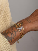 Meaningful Gold Vermeil and sterling silver Energy bracelet handmade by Leeloobird Jewlery baliwith a moon design on a light gray surface