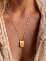 A gold vermeil Angelito necklace handmade by Leeloobird Jewelry Bali with a square-shaped medallion pendant.