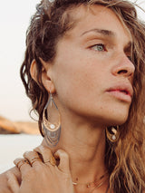 Model Wish earrings by leeloobird Bali featuring gold vermeil and sterling silver with mother pearl accents
